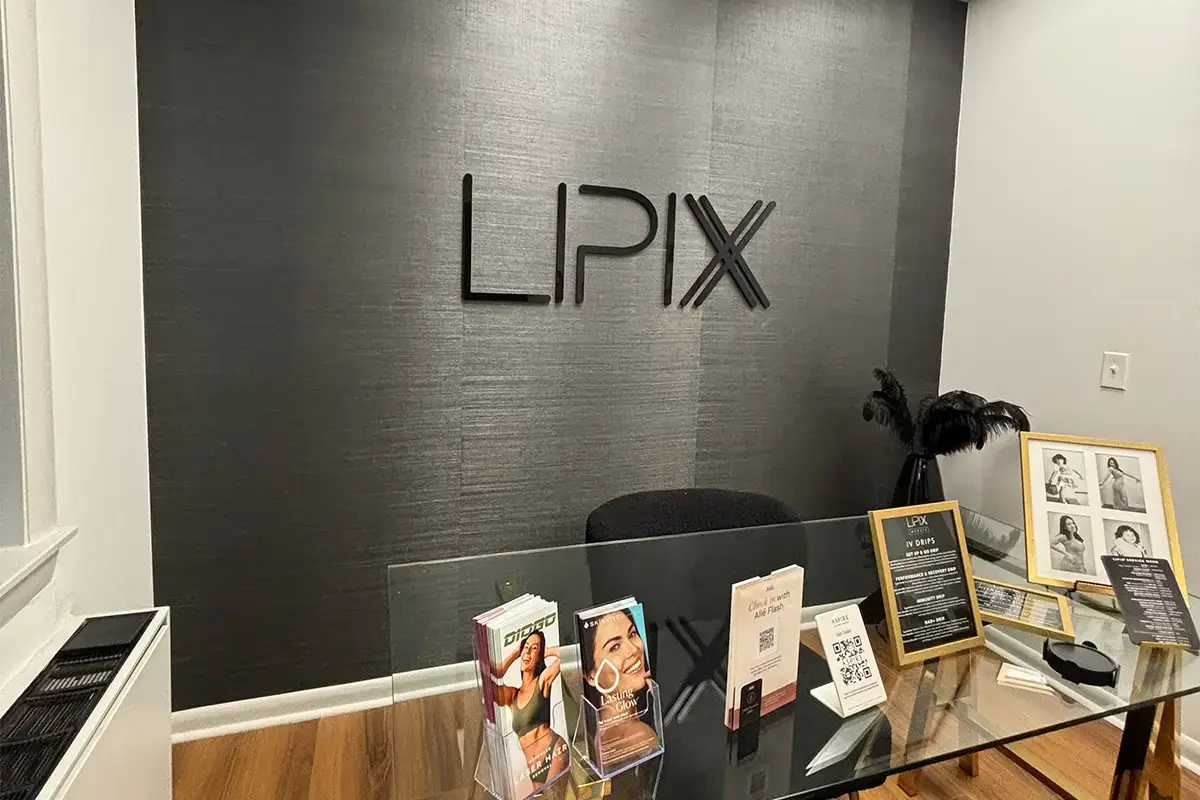 Flat cut acrylic letters spelling LPIX in modern office lobby