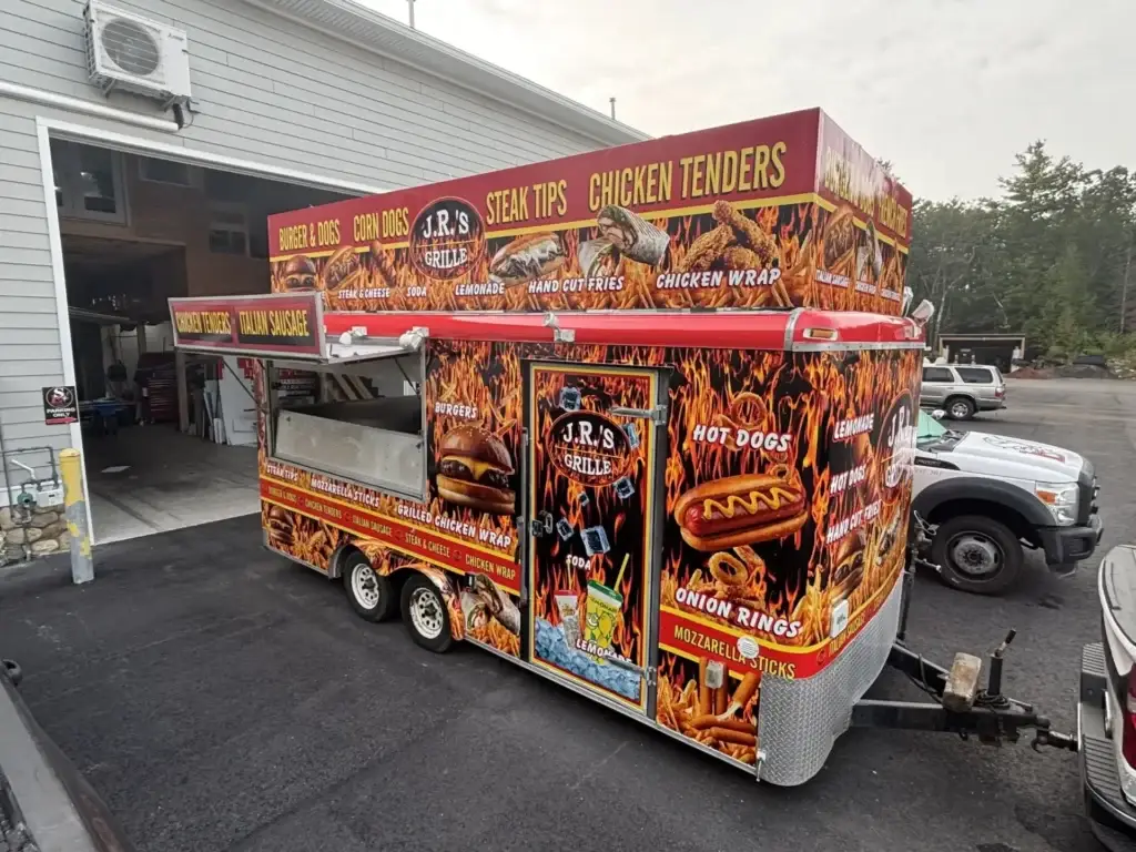 Food truck featuring "J.R.'s Grille" branding, showcasing menu items like chicken tenders, burgers, hot dogs, and onion rings, emphasizing local food options for small businesses in New Hampshire.