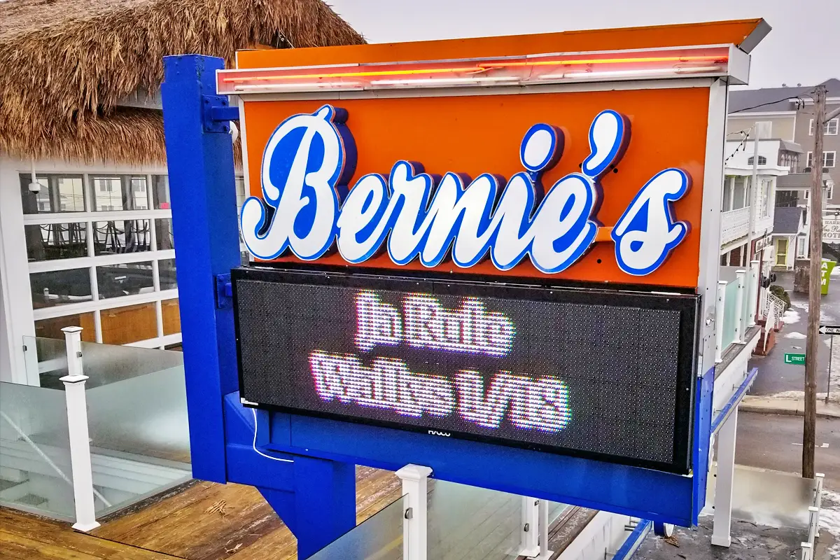 Bernie's sign showcasing vibrant lettering with digital display for promotions, emphasizing local business identity and custom sign services by Signs East.