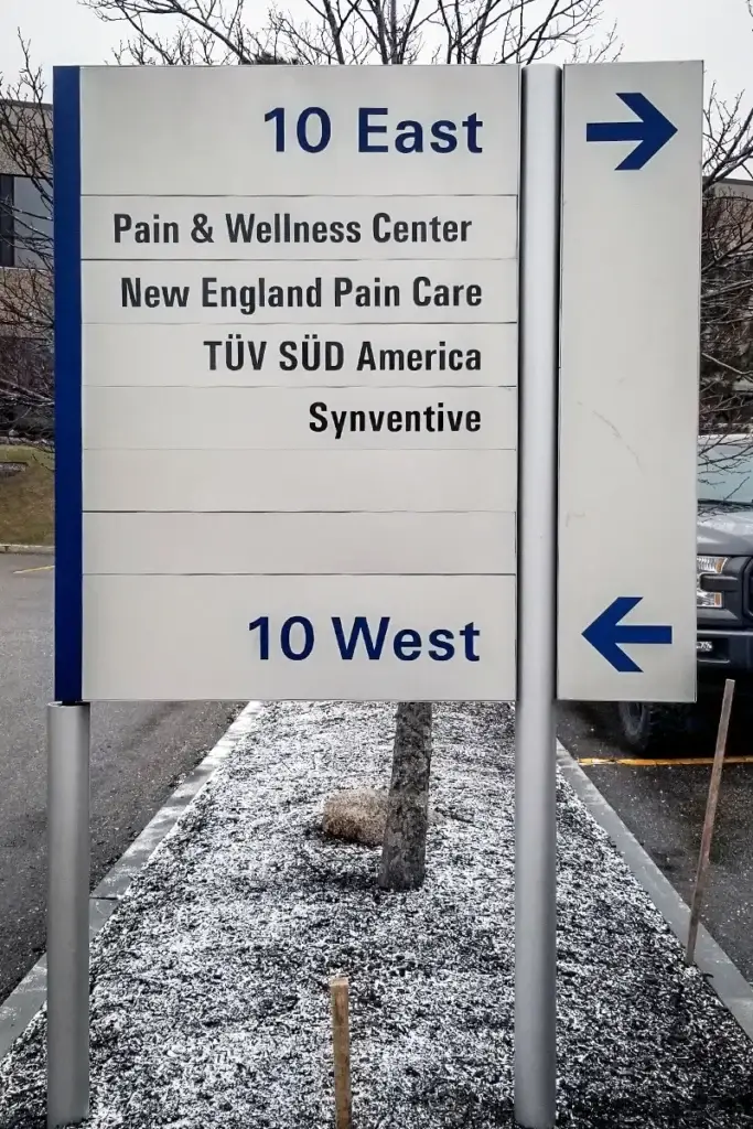 Person maintaining outdoor signage to ensure longevity and effectiveness
