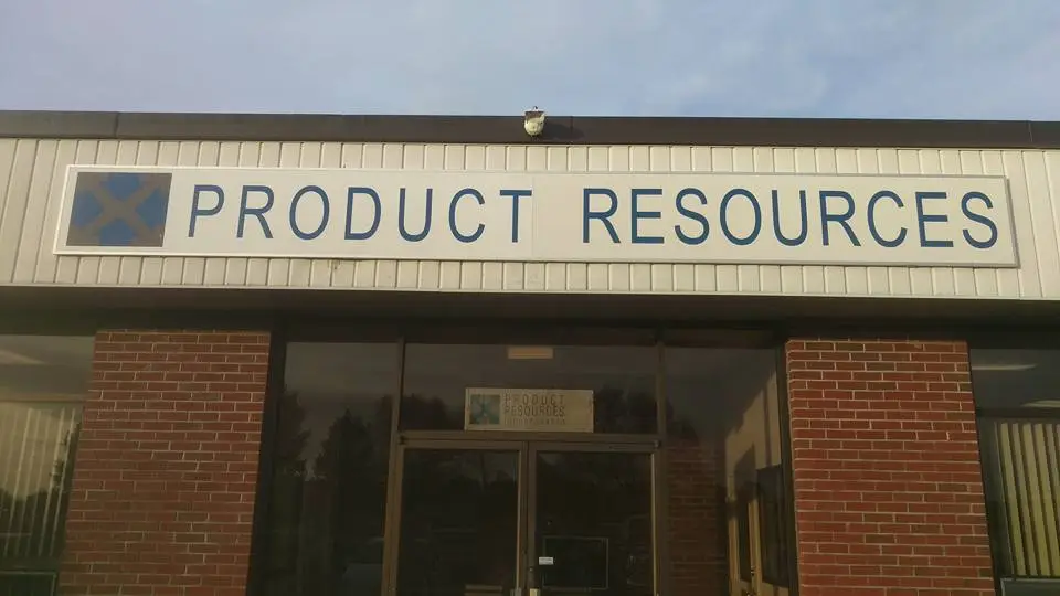Custom business awning sign featuring "PRODUCT RESOURCES" in bold blue letters, mounted above a storefront entrance with a brick facade, showcasing branding and visibility for commercial spaces.