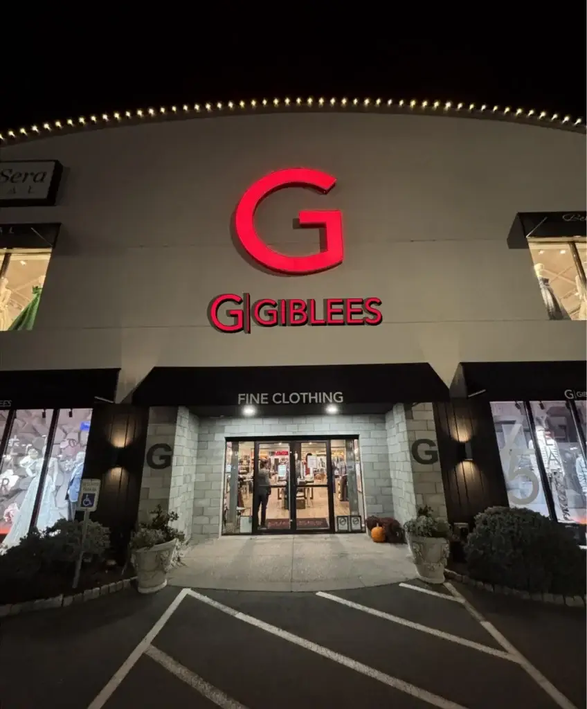 Illuminated channel letter sign for Gibblees Fine Clothing, facade attachment permitting example