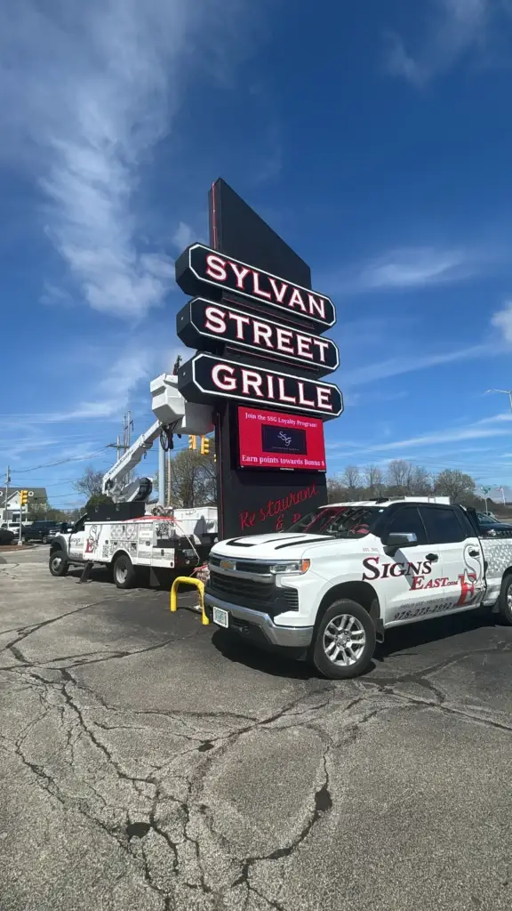 Signs East truck servicing the Sylvan Street Grille restaurant sign